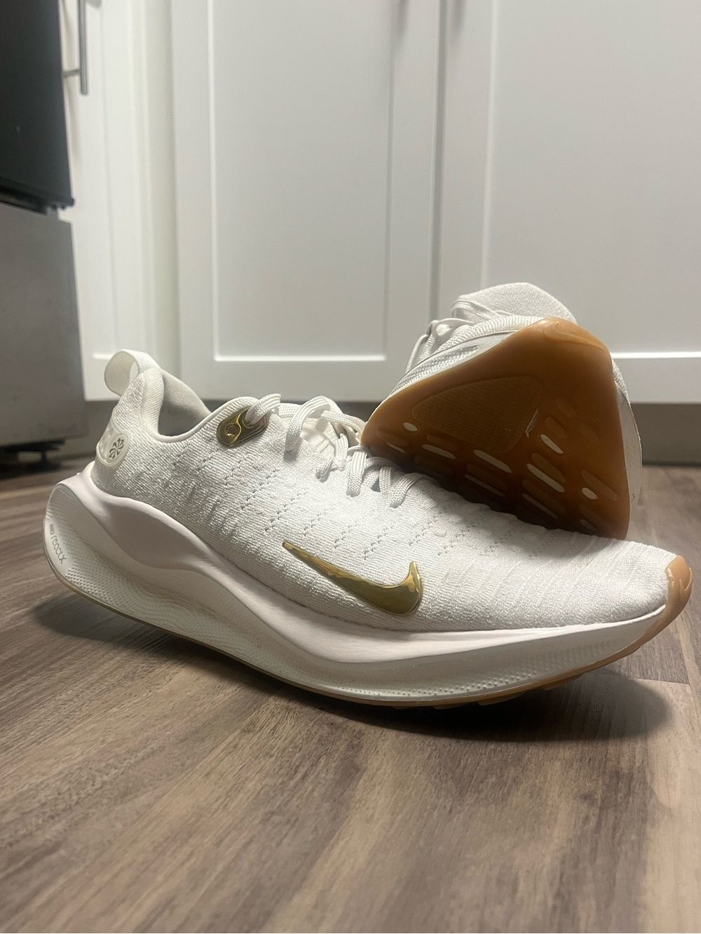 Nike White Women’s Athletic Sneakers with Gold Swoosh and Gum Sole